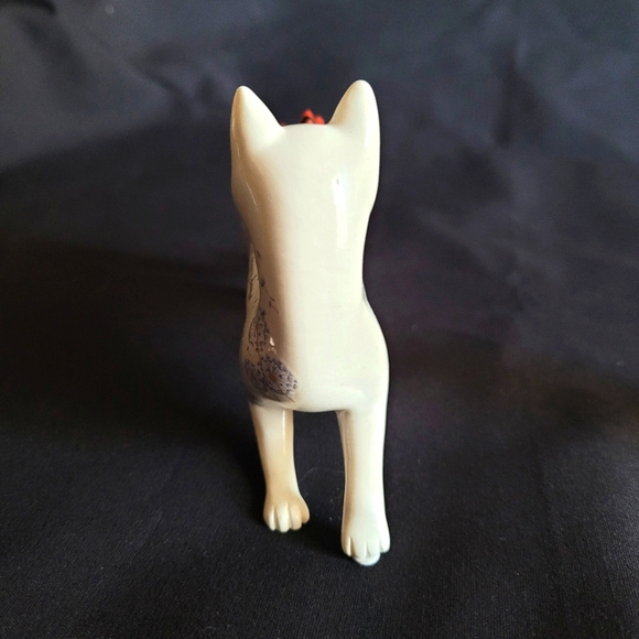 White Cat Looking Back at a Red Bird That Had Landed on His Back - Picture 2 of 12